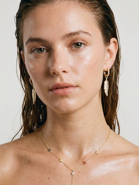 Gold-colored feather earrings
